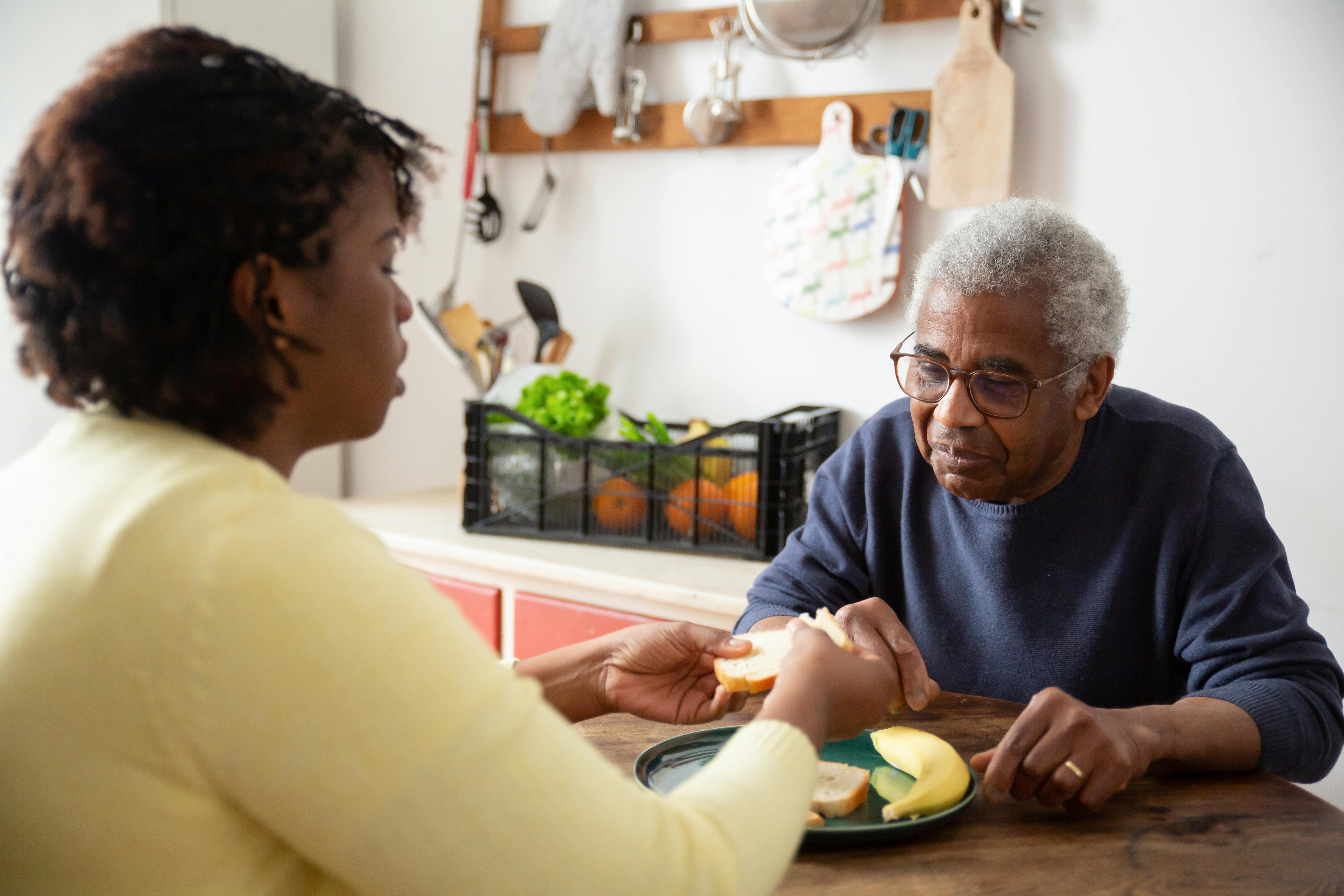 Caregiver helping an older adult at home